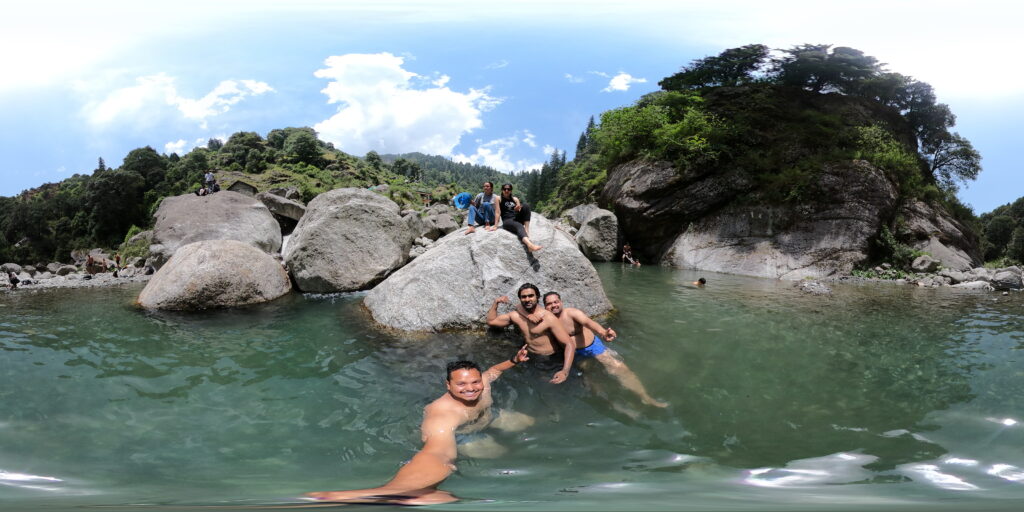 Young Adventurers Enjoying a Riverside Swim in Bir, Himachal: Embrace the Outdoors with Our Exciting Packages